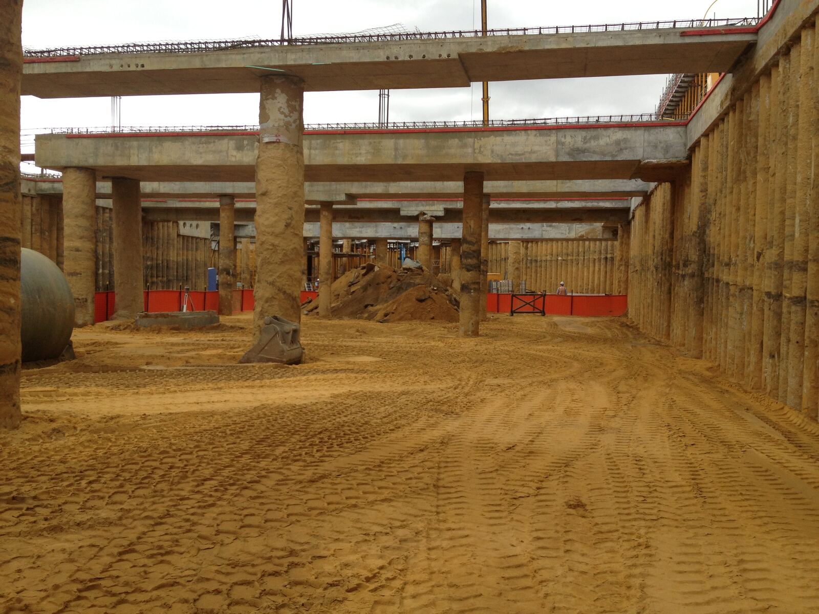 Loader between concrete columns in a basement dig