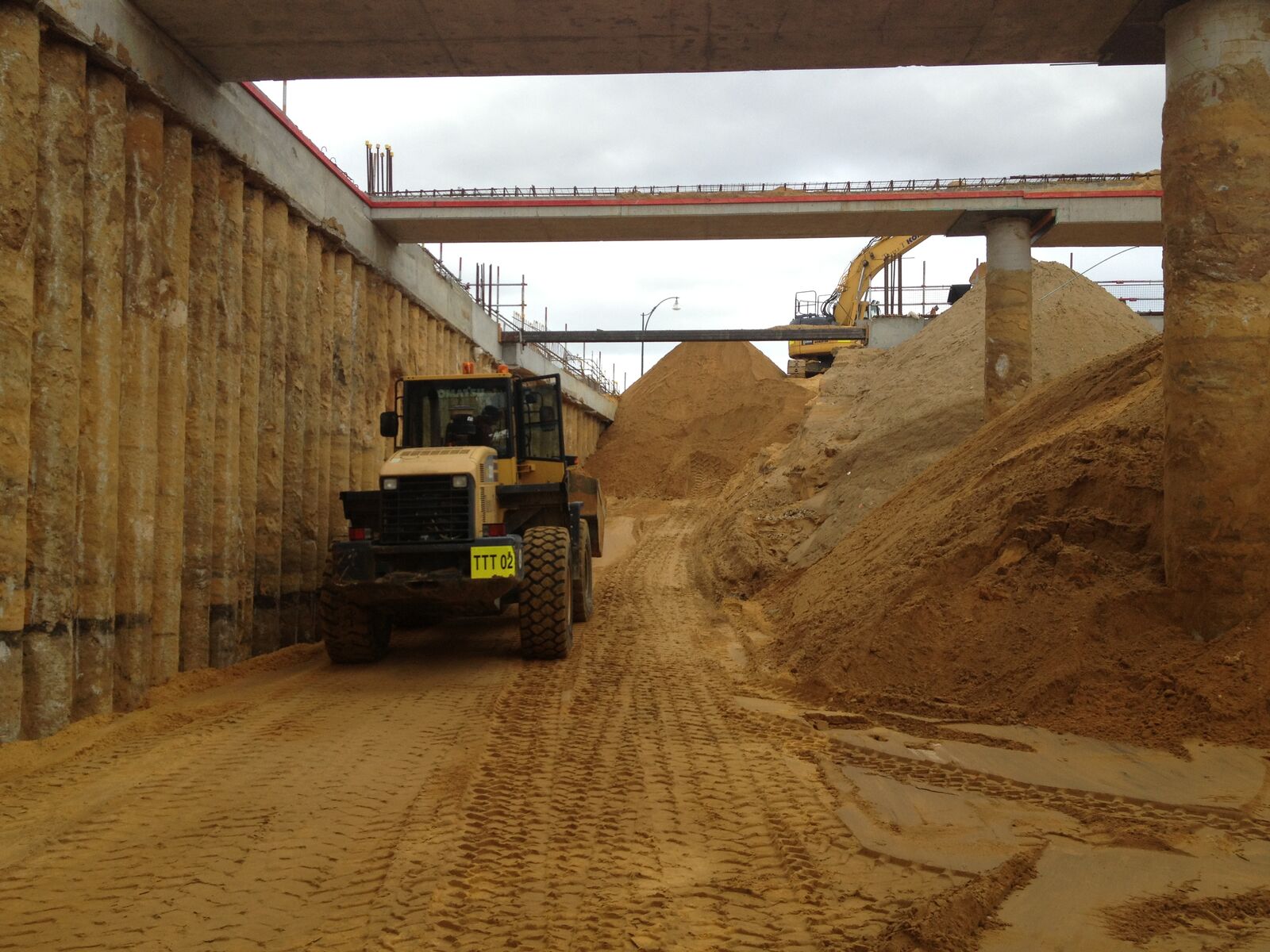 Loader working inside a deep basement excavation