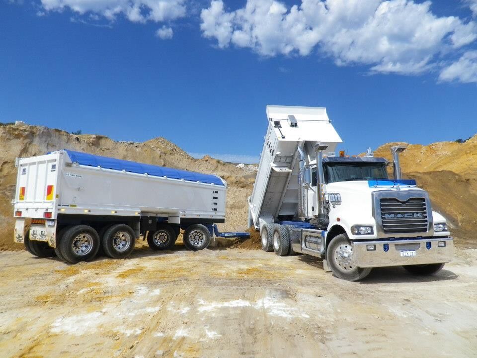 Truck and dog tipping at a quarry