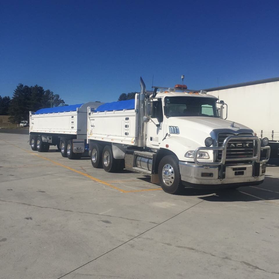 White Mack truck and dog trailer