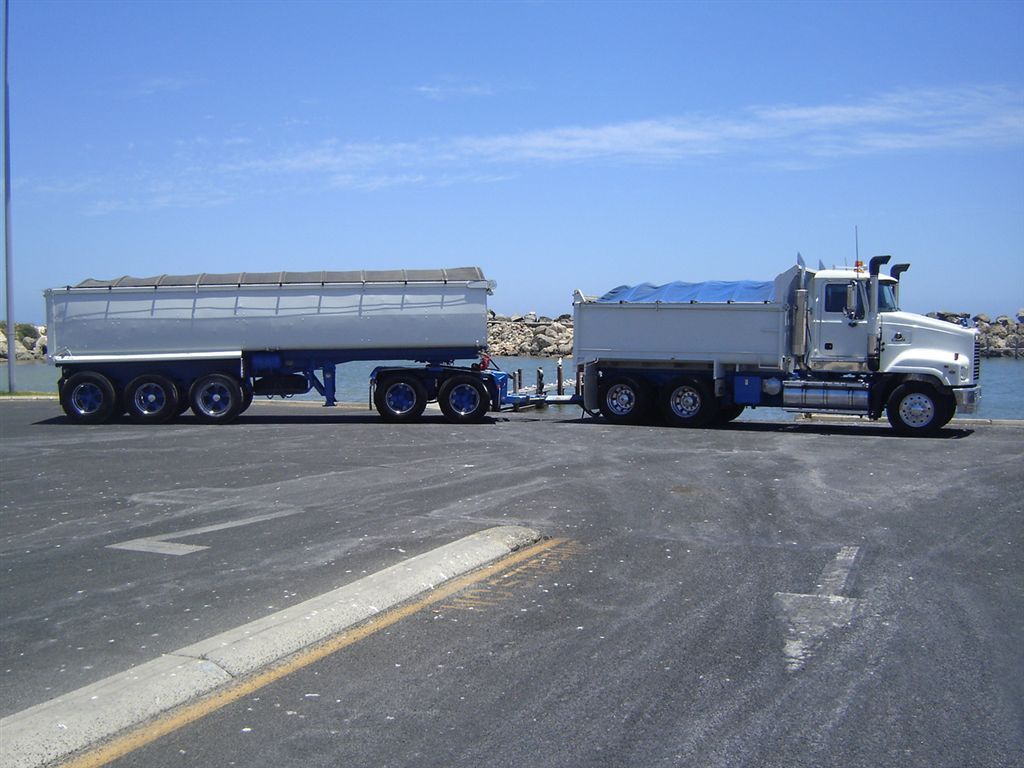 Truck and dog being loaded at a sand stockpile